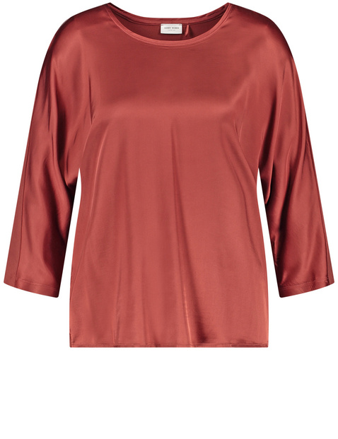 3/4-sleeve top with a fabric panel and a subtle sheen